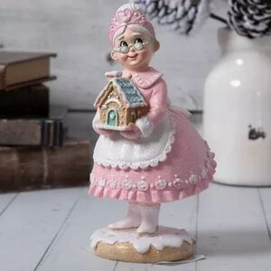 Mrs Claus holding holiday gingerbread house figure 8”